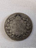 Close-up image of the obverse side of the 1934 Canada silver ten cent coin showing detailed wreath and crown design, denomination and date clearly visible.