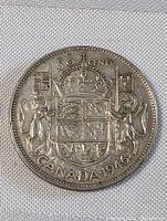 Obverse side showing the Canadian coat of arms with denomination and date