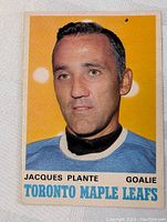 Front view of vintage 1970-71 OPC Jacques Plante hockey card in very good condition. Yellow background with player portrait and team name on front.