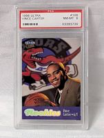 Front side of 1998 Fleer Ultra Vince Carter rookie card in PSA graded slab, showing player portrait with Toronto Raptors logo and 'Rookies' label.