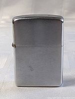 Front view of the silver Zippo lighter showing the brushed metal surface with some minor scratches.