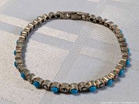 Top view of the linked sterling silver bracelet showing turquoise stones and marcasite stones alternating.