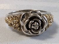 Front close-up of the sterling silver rose centerpiece and surrounding 10K gold leaves on band.