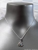 Sterling silver butterfly pendant with abalone inlay on an 18-inch sterling silver chain displayed on a black neck form.