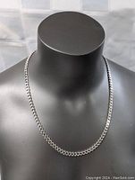 Full view of sterling silver necklace displayed on black bust, showing entire 22 inch length and thick chain design.