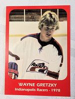 Front side of the 1978 Wayne Gretzky Indianapolis Racers hockey card showing Gretzky in team jersey on ice, bordered in red.
