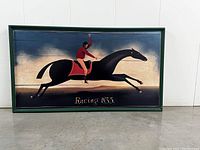 Front view of the framed retro racehorse painting with jockey raising an arm, dark horse with red saddle, and the text 'Racing 1835'.