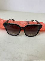 Front view of FYSH sunglasses showing brown gradient lenses and tortoiseshell frame with FYSH logo on lens.