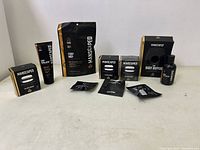 Wide shot showing all Manscaped items included in the lot arranged on a table: The Body Buffer, Crop Mop powder, replacement blades, and other sachets.