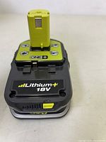 Close-up of Ryobi Lithium+ 18V battery pack showing the top and front labels and battery cells.