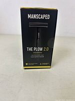 Front view of the Manscaped The Plow 2.0 safety razor box showing product name and image of the razor.