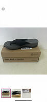 Side view of black sandal on top of box.