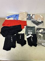 Full lot view showing multiple panties in different colors and patterns laid out on the floor