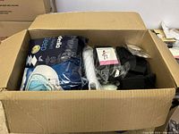 Open box view showing large sleeping pillow and workout bands