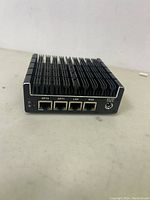 View of front side showing 4 Ethernet ports (OPT2, OPT1, LAN, WAN) and DC power input port.