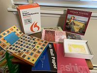 Overview image showing Dragon NaturallySpeaking software box, vintage Posters 2011 calendar, Gustav Klimt postcards, colorful stationery, and postcard packs