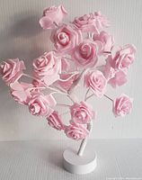 Pink rose tree lamp with all lights off showing the structure and detail of the pink roses and white stand.