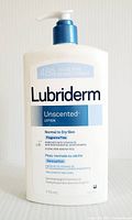 Front view of the 710 ml bottle of Lubriderm Unscented Lotion showing brand, usage for normal to dry skin, fragrance free, and other features.