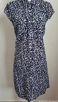 Front full view of Tommy Hilfiger ladies dress, black and white floral print, size medium, with button front and capped sleeves.