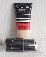 Image showing one tube of CoverGirl Outlast Active foundation with two sealed Revlon PhotoReady Concealers.