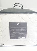 Packaged white king size comforter with Hotel Collection label and product information