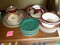 Wide shot showing Salem Aristocrat tea ware including tea cups, bowls, and plates, along with green malachite pattern cake plates in the foreground.