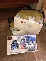 Two boxed Tabletops Gallery Misto Green 4-piece place settings with round green plates visible on top.