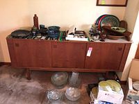 Front view of entire credenza with three sliding doors closed and top surface showing wear