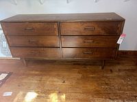 Full front view showing six drawers, handles and leg style