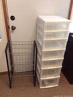 Photo showing plastic storage unit with six drawers and metal shelf with wood frame side by side.