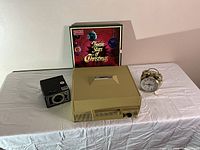 Full view of all items on a table: record player, camera, clock and record