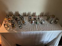 Full collection of all 20 glasses displayed on a table including Smurfs, Muppets, Star Wars, and Battlestar Galactica characters