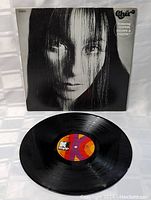Vinyl record with multicolored label and black and white cover featuring Cher's close-up portrait.