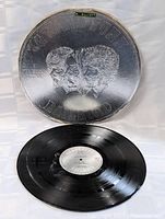 Photo showing vinyl record with reflective silver embossed cover featuring band faces and title E Pluribus Funk by Grand Funk Railroad