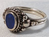 Close-up side angled view showing lapis lazuli stone and detailed silver bead and rope design with dark patina