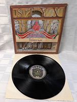 Vinyl record LP shown with brown framed Paradise Theatre cover