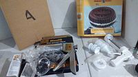 Overview of cake pans and icing decorating presses including packaged Easter egg pan and chocolate cake pan box