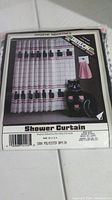 Photo of packaged new shower curtain with cat silhouettes design and pink grid background
