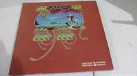 Front cover of the Yessongs album with artistic design and band name, showing the condition of the album cover.