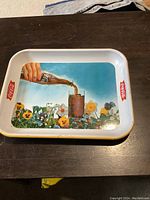 Top view of the rectangular Coca Cola tin tray showing the colorful vintage ad and side logos.