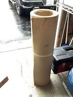 Full view of upright large roll of brown floor protection paper