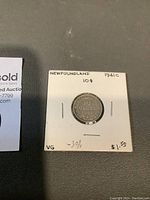 Front view of Newfoundland silver 10 cent coin dated 1941C in white cardboard holder with handwritten labels.