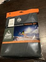 Packaged Outland thermal set with visible branding and size.