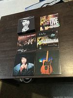 Five items in the set displayed on a table showing the outer box, 4 CDs, and 1 DVD with clear cover art.