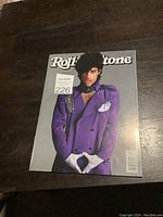 Photo of vintage Rolling Stone magazine with Prince on the cover showing distinct purple jacket and accessories.