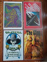 Group photo of all 4 concert posters arranged on wooden floor, showing Grateful Dead, The Who, and two other colorful posters.