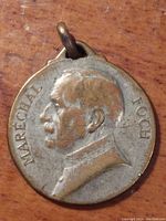 Front side of circular metal pendant medal featuring profile bust of Maréchal Ferdinand Foch with text 'Marechal Foch' around the edge.