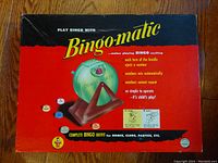 Photo of vintage bingo game box top with bingo-matic bingo cage and balls illustration