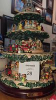 Full view of the multi-tiered sculpture showing Disney characters, Christmas train, and decorations.