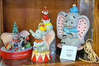 Full view of Dumbo teapot, sugar bowl, Dumbo Christmas 2006 figurine, and Dumbo lamp on shelf